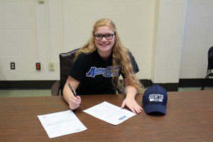 Kelsey Johnstone signs her national letter of intent to join the Assumption College women's swim team next year. (Submitted photo)