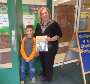 Third-grader Richard Moritkl meets volunteer Maryann Tanski to bring her to class for the Reach Out and Read event Thursday. (Photo by Amy Porter)
