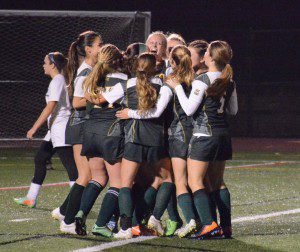 The Rams celebrate after Alex Mello scores the game-tying goal on a penalty kick midway through the second half of a MIAA West Sectional Division 3 Girls' Soccer semifinal Thursday night at Clark Field in West Springfield. (Photo by Lynn F. Boscher)