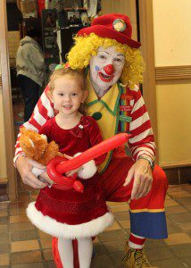 Aviana Tenerowicz poses for a picture with Fumbles, a Melha Shrine Clown. (Photo by Michelle Hamel)