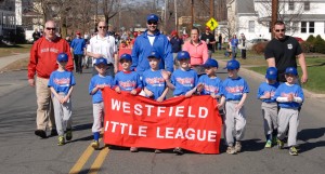 Children of all ages parade through the city's streets to kick off the 2015 Westfield Little League season in April. (Staff Photo)