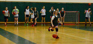 Teammates look on as a player for the Southwick High School girls