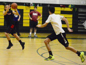 The Rams run a passing drill the length of the court during the second day of tryouts for Southwick High School boys' basketball Tuesday. (Photo by Chris Putz)