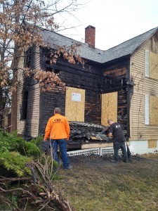 Crews work to secure 64 Mill St. following a fatal fire. (Photo by Christine Charnosky, December 24, 2015). 