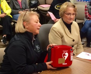 Susan Canning of KEVS Foundation, at left, presents an AED to the SOuthwick Regional School Jan. 19 to Curriculum Director Maureen Wilson. (Photo by Hope E. Tremblay)
