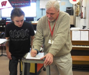 Lowell Mason Award recipient Patrick Kennedy explains music theory to freshman Nathan Emmonds after class. (Photo by Amy Porter)