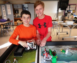 Seventh grade teammates Tim Nacewicz and Riley Sullivan with the robot they built for the FIRST LEGO League at Middle School South. "The robotics inspires me to be better," Sullivan said. (Photo by Amy Porter)