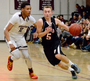 Westfield’s John O’Brien (5) dribbles past Devonte McCall (11) Tuesday night at Amherst. (Photo by Chris Putz)