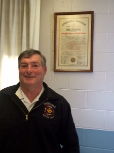 Westfield Fire Deputy Chief James Kane stands under the Westfield Fire Department's certificate of affiliation when the department first joined the union. Kane served as union president, captain, and deputy chief throughout his 36 years with the department. Feb. 25 was Kane's last day on the job before retirement. (Photo by Hope E. Tremblay)