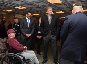 Gov. Charlie Baker greets Holyoke Soldiers Home's resident and WWII Navy Veteran Dick Vaillancourt. (Photo by Dennis Hohenberger)