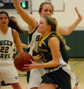 Southwick’s McKenzie Sullivan attempts to drive the baseline against the Greenfield Green Wave. (Photo by Chris Putz)