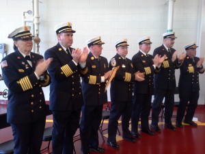 Area fire chiefs applaud the efforts of the first class to graduate from the Massachusetts Firefighting Academy in Springfield. (Photo by Dennis Hohenberger)
