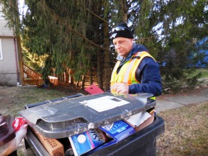 Bruce Langtange of the Westfield DPW inspects recycling barrels for ineligible materials in the Meadow Street neighborhood Wednesday. (Photo by Amy Porter)