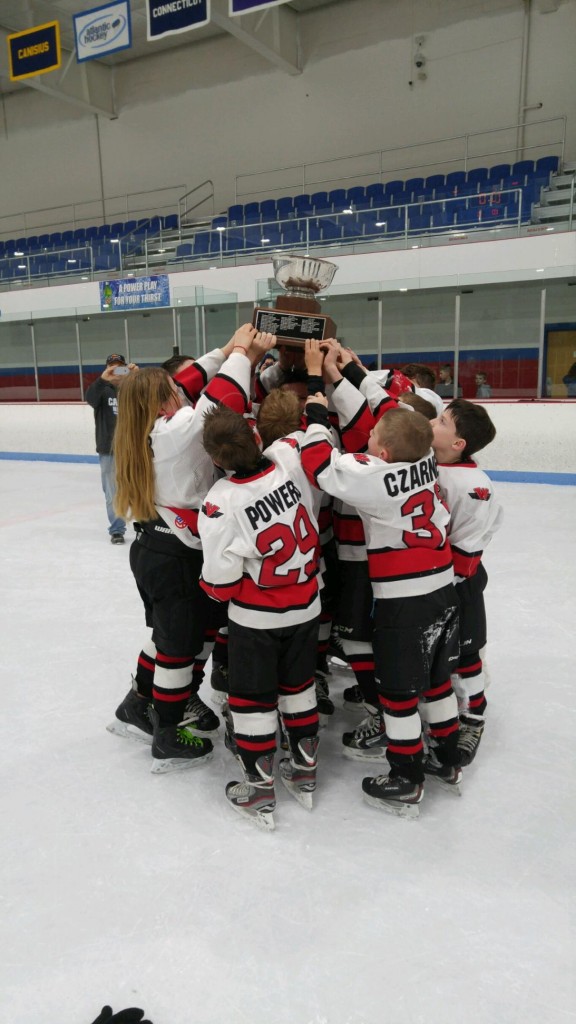 The Westfield Youth Hockey Squirt 1 players hoist a championship trophy. (Submitted photo)