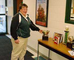 White Oak School athletic director/coach Joanne Daley points to one of several sportsmanship awards that her sports program has captured in recent years . (Photo by Chris Putz)