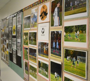 A display of pictures highlighting the achievements of White Oak School's student-athletes adorn the wall on one of the halls in the school. (Photo by Chris Putz)