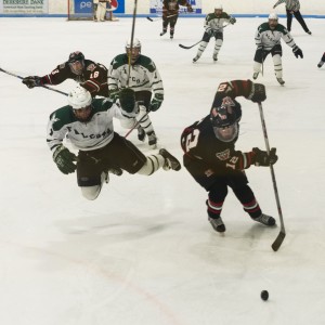 Westfield's John Danahey (12) looks to take control of the puck as a Falcon looks to swoop in from behind. (Staff File Photo)