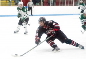 Westfield's Mario Metallo (4) races the puck up the ice against Minnechaug in last Thursday's championship against Minnechaug. (Photo by Bill Deren)
