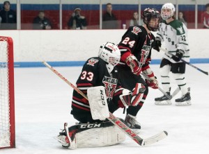 Westfield High School goalie Cameron Parent (33) gets into position to make a save in the Division 3 Western Massachusetts championship game. Defenseman Sean Moorhouse (24) was also a key to the Bombers' success against Minnechaug. (Photo by Bill Deren)