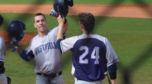 Nate Barnes (24) congratulates Anthony Crowley at home plate after his first collegiate home run on Tuesday in Auburndale, Fla. (Photo courtesy of Westfield State Sports)