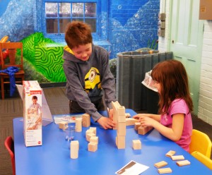 Gianna, 6 and Noah, 8 build a marble run out of blocks.