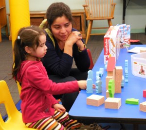 Emily, 5 and Alicia Booth play with foam figures in the civil engineering kit.