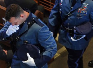 A trooper fights back emotion as he leaves the church after funeral service for Trooper Thomas L. Clardy at Saint Michael's Church in Hudson, Mass., on Tuesday,March 22, 2016. Clardy, was killed when a car slammed into his cruiser as he was stopping another driver. (Nancy Lane/The Boston Herald via AP, Pool)