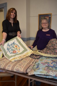Shannon Brown and Jean Zimmerman showcase the quilts that Zimmerman made for those staying at the Samaritan Inn. The women are members of First Congregational Church's World Service Committee that raises funds during the year to benefit organizations including the Samaritan Inn.
