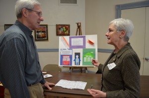 Mike Cichonski is given some background on The Kinship Fund by Ann Lentini of Domus, Inc. during a coffee hour at First Congregational Church on Sunday.