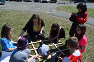 Carolyn Duval, a senior at Westfield State University, works with students on the grid construction.