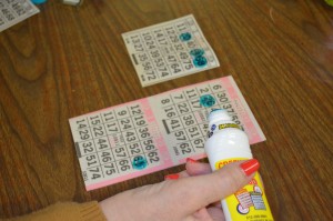 Darlene Barnes marks her paper bingo cards as the game progresses on Sunday at the Southwick Grange.