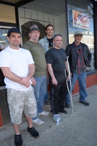 The "Broken" Bones Benefit Show to assist Kevin Carbone, third from left, is being supported by bands including Doug Cotton of Stumpy McToad, second from left, and Mental Pause members Paul Thibault V, Alex Donoghue, in back, and Patrick Reilly. The men reviewed some logistics recently at Whip City Music on Elm Street.