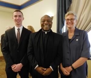 The Reverend Warren Savage (center), Catholic chaplain for the Interfaith Center at Westfield State, presented awards to sophomore Philip J. Sheedy (left) and Dr. Elizabeth Preston for their support of the Common Goods food pantry at the university. (Photo by Amy Porter)