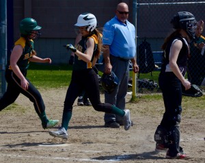 The Rams score a run as the Central catcher, at right, looks toward the field of play. (Photo by Chris Putz)