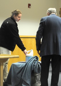 Jennifer Gingras of Holyoke demonstrates for her lawyer, Thomas D. Whitney, how she placed a bottle of bleach atop a crate housing her boyfriend’s dog during her trial on a charge of cruelty to an animal in Westfield District Court last week. She was found guilty of dousing the dog with bleach. (Photo ©2016 Carl E. Hartdegen)