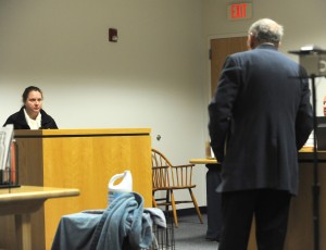 Attorney Thomas D. Whitney questions his client, Jennifer Gingras of Holyoke, during her trial on a charge of cruelty to an animal in Westfield District Court last week. In the foreground is the crate in which her boyfriend’s dog was housed when it was doused with bleach. (Photo ©2016 Carl E. Hartdegen)