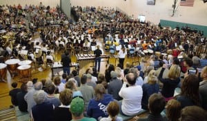All the members of the bands and their directors, gather on the auditorium floor to perform as one for the audience. (Photo by Lynn Boscher)