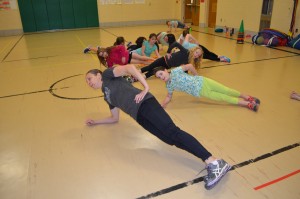 Michelle Urbanski leads the BOKS program at Highland Elementary School. She is seen here demonstrating the importance of performing planks in one's fitness routine.
