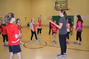 Michelle Urbanski explains the rules of "Everybody Tag" during the BOKS program at the Highland Elementary School.