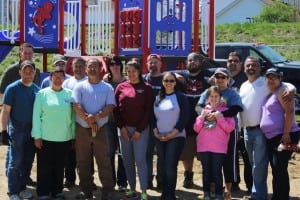 The volunteers pose for a picture in front of the playscape they helped install at Whitney Playground in honor of Westfield Police Officer Jose Torres. (Photo by Kellie Adam)
