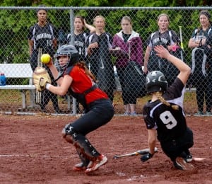 Westfield catcher Morgan Zabielski, left, looks toward third base after recording a force out at home plate before Longmeadow base runner Katelyn Joyal (9) can slide in safely. (Photo by Chris Putz) 