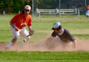 Westfield's baserunner kicks up dust as he beats the Agawam throw and slides in safely to second base Thursday at Shea Field. (Photo by Chris Putz)