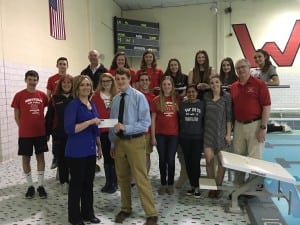 Kelli Wood, Accounting Associate at Westfield Bank, presents a check to Westfield High School diver Lucas Stanton, his coaches, and teammates for the purchase of a new 1-meter diving board. (Photo submitted)