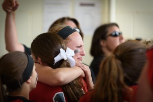 Brittany Kowalski gets a comforting hug from teammates after the Bombers’ loss to Agawam in the Western Massachusetts Division 1 softball championship Monday at the University of Massachusetts-Amherst. (Photo by Marc St. Onge)
