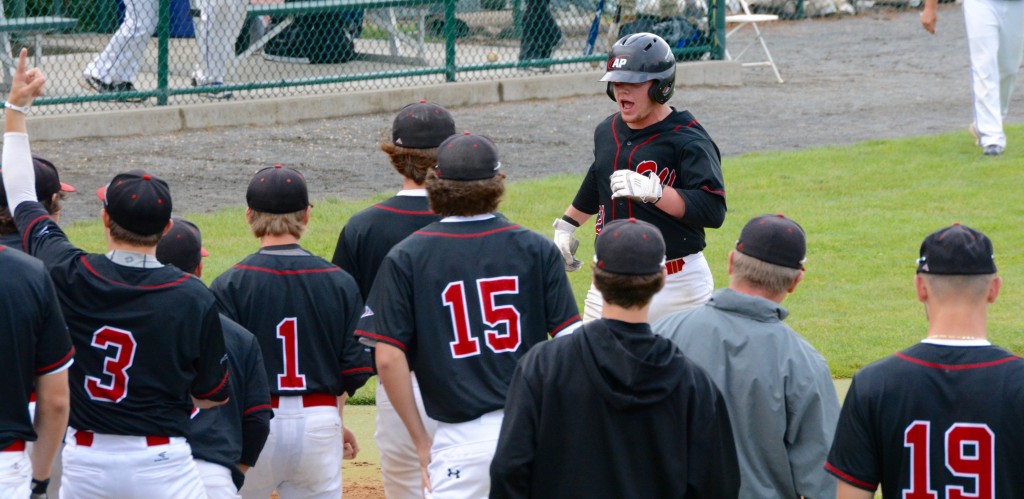 Westfield catcher Anthony Clark is greeted by teammates at home plate after hitting a home run Saturday. (Photo by Chris Putz)