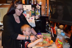 Samantha Carboneau and her son Mason cut up apples for a chicken salad they are preparing for the "meal train" to benefit the Flanagan family in Westfield.
