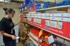 Sarah Farnham of Russell helps stock shelves at the St. Vincent dePaul Food Pantry at St. Mary's Church in Westfield.