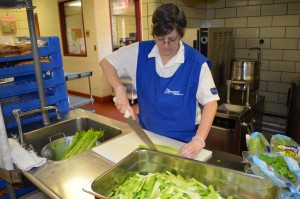 Jill Kordana preps the celery stalks in the kitchen of the South Middle School on Wednesday morning as part of the Boys & Girls Club of Greater Westfield's free summer lunch for children in the city. During the school year, Kordana serves as cafeteria manager at the Abner Gibbs School.