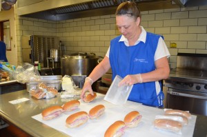 Cindy Stover stuffs the ham and cheese sandwiches into baggies for Wednesday's free summer lunch for children in the city. The program is sponsored by the Boys & Girls Club of Greater Westfield. During the school year, Stover serves as cafeteria manager at the Munger Hill School.