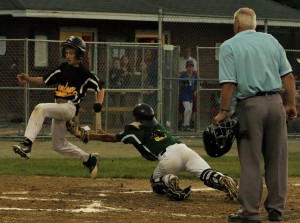 Berkshire Insurance Group catcher Dalton Bessette dives back toward home plate to tag out a Camfour base runner Wednesday night in an Amanti Cup game at Bullens Field. (Photo by Kellie Adam)